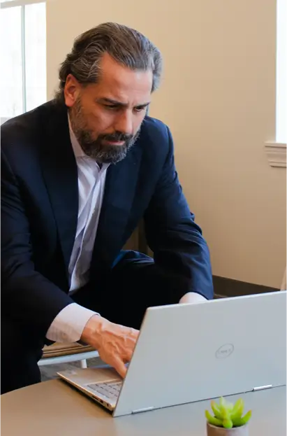 Attorney Vincent Capuano working on a laptop
